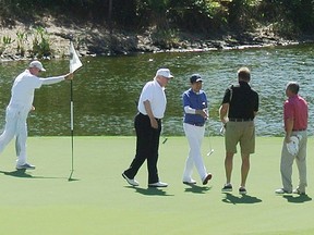 US President Donald Trump (2nd L) and Japan's Prime Minister Shinzo Abe (C) enjoy playing golf in Florida on February 11, 2017.