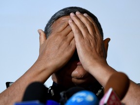 Royal Malaysian Police chief Khalid Abu Bakar demonstrates the actions of one of the female suspects believed to be involved in the assassination of Kim Jong-Nam.