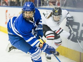 Kelly Terry (left) of Team Blue controls the puck against Meghan Grieves of Team White at the CWHL All-Star Game in Toronto on Feb. 11.