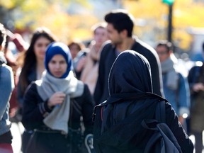 Women wearing hijabs walk along St. Catherine street, pictured in Montreal on Monday, October 22, 2012