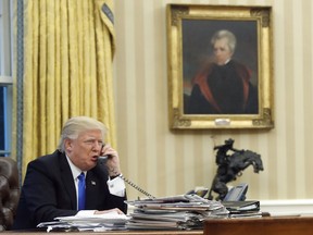 U.S. President Donald Trump speaks on the phone with Australian Prime Minister Malcolm Turnbull in the Oval Office of the White House in Washington on Jan. 28.
