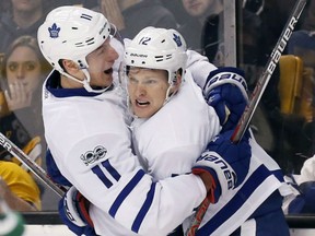 Zach Hyman, left, and Toronto Maple Leafs teammate Connor Brown celebrate a goal during the third period of their game against the Bruins in Boston on Saturday night.