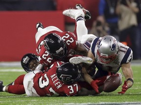 New England Patriots' Julian Edelman makes a catch as Atlanta Falcons' Ricardo Allen and Keanu Neal defend, during the second half of the NFL Super Bowl 51 football game Sunday, Feb. 5, 2017, in Houston.