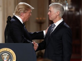 President Donald Trump shakes hands with Judge Neil Gorsuch, his choice for Supreme Court associate justice.