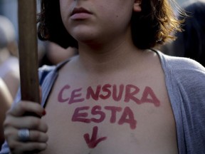 A woman with the text in Spanish written on her chest " Censor this," protests during a bare-breasted demonstration in Buenos Aires, Argentina, Tuesday, Feb. 7, 2017.