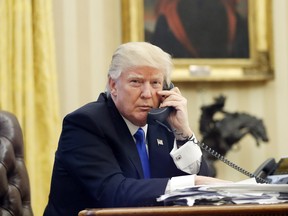 Donald Trump speaks on the phone in the Oval Office, Jan. 28, 2017