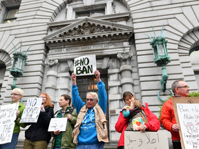 Protesters stand in front of the U.S. Court of Appeals for the Ninth Circuit in San Francisco, on Feb. 7, 2017, where a arguments were heard on Tuesday on whether to lift a nationwide suspension of President Donald Trump's travel ban targeting citizens of seven Muslim-majority countries.