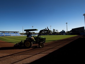 A worker grooms the dirt in preparation to the Toronto Blue Jays baseball spring training in Dunedin, Fla., on Sunday, February 12, 2017.