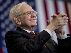 FILE - In this Aug. 1, 2016, file photo, Berkshire Hathaway Chairman and CEO Warren Buffett applauds at a rally for Democratic presidential candidate Hillary Clinton in Omaha, Neb. Buffett's company nearly quadrupled its investment in Apple to over 57 million shares during the last three months of last year. (AP Photo/Andrew Harnik, File) ORG XMIT: NYHK205