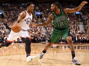 DeMar DeRozan of the Raptors drives to the basketball while being defended by the Boston Celtics' James Young during second half action in Toronto on Friday night.