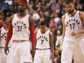 Raptors guard Kyle Lowry (7) and teammates walk off the court after losing to the Detroit Pistons in Toronto on Sunday.