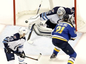 Winnipeg Jets' goaltender Ondrej Pavelec sticks out his right pad to deny Patrik Berglund of the St. Louis Blues from close in during NHL action Tuesday night in St. Louis. Pavelec was a standout with 24 saves as the Jets posted a 5-3 victory.