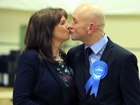 Conservative candidate Trudy Harrison and her husband Keith kiss after winning the Copeland by-election at Whitehaven Sports Centre in Cumbria, Britain Friday, Feb. 24, 2017.