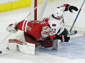 Chris Kelly of the Ottawa Senators runs into Carolina Hurricanes' goaltender Eddie Lack during NHL action Friday in Raleigh, N.C. Lack recorded the shutout in a 3-0 victory over the Sens.