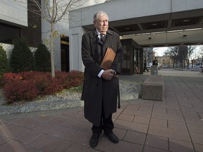 Bruce Carson stops as his lawyer speaks with journalists outside the courthouse, Tuesday, November 17, 2015 in Ottawa. Carson, a former top aide to Stephen Harper, has been found not guilty of influence- peddling.