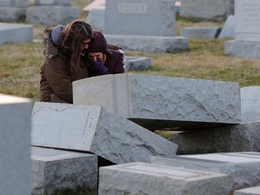 Melanie Steinhardt comforts Becca Richman at the Jewish Mount Carmel Cemetery.