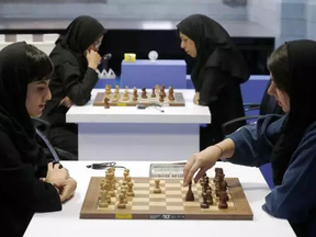 Iranian chess players play at the Chess Federation in the capital Tehran on 2016.   For some Iranian players the veil is not a sign of oppression, but one of their teammates was just kicked off the team for not wearing the veil during a match in Spain.