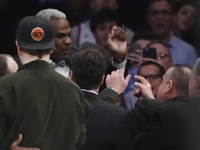 Former New York Knicks player Charles Oakley exchanges words with a security guard during the first half of an NBA basketball game between the New York Knicks and the LA Clippers Wednesday, Feb. 8, 2017, in New York.