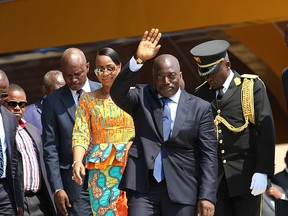 In this Thursday, June 30, 2016 file photo, Congolese President Joseph Kabila, centre, waves as he and others celebrate the Democratic Republic of Congo, DRC, independence in Kindu, Congo.