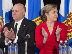Kellie Leitch, right, and Kevin O'Leary applaud at the Conservative leadership candidates' debate, in Halifax on Saturday, Feb. 4.