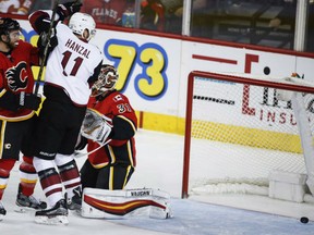 Martin Hanzal of the Arizona Coyotes celebrates a goal from close in against Calgary Flames' goaltender Chad Johnson during NHL action Monday night in Calgary. At left is Flames' defenceman TJ Brodie. The Coyotes surprised the Flames to the tune of 5-0 on this night.