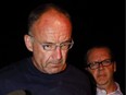 Douglas Garland is escorted into a Calgary police station in connection with the disappearance of Nathan O'Brien and his grandparents in Calgary, Alta., on July 14, 2014.