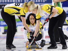 Manitoba skip Michelle Englot (centre) delivers a shot against Saskatchewan during the Scotties Tournament of Hearts in St. Catharines, Ont., on Feb. 19.