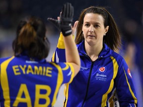 Alberta alternate Heather Nedohin (right) gives third Lisa Eyamie a high five after a win over Saskatchewan during the Scotties Tournament of Hearts in St. Catharines, Ont., on Feb. 21.