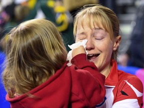 Kali, 3, daughter of Canada third Amy Nixon, wipes her mom's tears following her winning game against Northern Ontario for bronze at the Scotties Tournament of Hearts on Feb. 26.