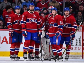 Montreal Canadiens players wait to hear the referee's ruling on a play against the Edmonton Oilers on Feb. 5.