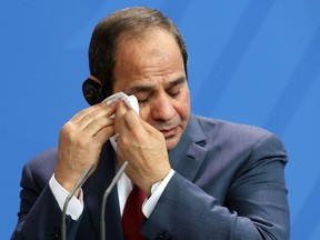 Egyptian President Abdel Fattah el-Sisi wipes his brow during a news conference with German Chancellor Angela Merkel on June 3, 2015 in Berlin, Germany.