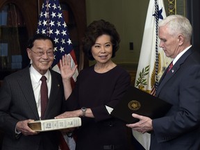 Vice President Mike Pence, right, swears in Transportation Secretary Elaine Chao, second from right, in the Eisenhower Executive Office Building in the White House complex in Washington, Tuesday, Jan. 31, 2017.