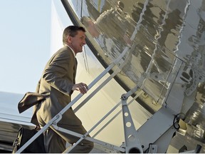 In this Feb. 12, 2017, photo, then-National Security Adviser Michael Flynn boards Air Force One at Palm Beach International Airport in West Palm Beach, Fla., as he return to Washington with President Donald Trump.