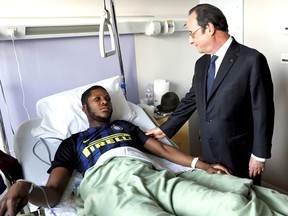 France's President Francois Hollande, right, stands next to the alleged victim, identified only by his first name Theo, at Robert Ballanger hospital north of Paris on Tuesday, Feb. 7, 2017.