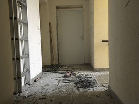 Wreckage of an entrance of an apartment building after a raid of a French anti-terrorist police unit in Clapiers, southern France, Friday, D-Feb. 10, 2017.