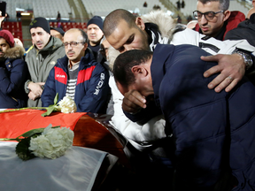 Mourners pay their respects during a funeral ceremony in Montreal for three of the victims of the deadly shooting at Quebec City's Islamic Cultural Centre mosque, Feb. 2, 2017.