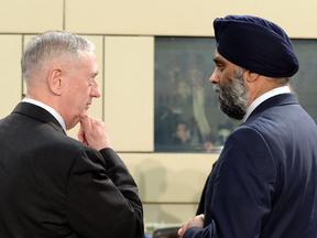 U.S. Secretary of Defence James Mattis talks to Canadian Defence Minister Harjit Sajjan ahead of a NATO Defence Ministers' meeting in Brussels on Feb. 16, 2017.