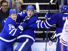 Toronto Maple Leafs forwards Auston Matthews (centre) and William Nylander celebrate after Matthews' second goal against the Montreal Canadiens on Feb. 25.