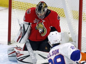 Ottawa Senators goalie Craig Anderson (left) makes a save on New York Islanders centre Brock Nelson on Feb. 11.