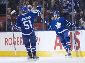 Toronto Maple Leafs forward William Nylander, right, celebrates with teammate Jake Gardiner after scoring his team's fourth goal against the Winnipeg Jets on Feb. 21.