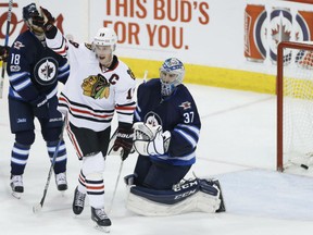 Chicago Blackhawks captain Jonathan Toews celebrates a goal by teammate Duncan Keith's against Jets goalie Connor Hellebuyck during the third period of their game in Winnipeg on Friday night.