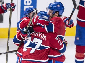Shea Weber, right, and Brendan Gallagher hug Canadiens teammate Alex Galchenyuk after his game-winning goal in overtime against the Columbus Blue Jackets in Montreal on Tuesday night.