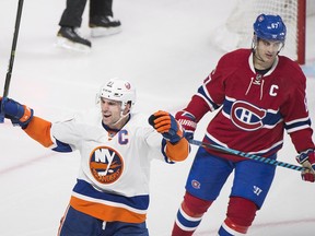 New York Islanders captain John Tavares (91) celebrates a goal by teammate Anders Lee against the Montreal Canadiens as Canadiens captain Max Pacioretty (67) look on during second period NHL hockey action, in Montreal on Thursday, February 23, 2017.