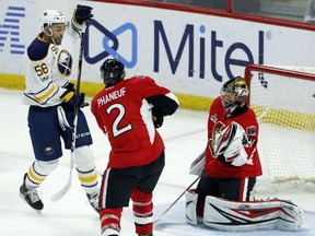 Buffalo Sabres' Justin Bailey scores on Senators goalie Craig Anderson as defenceman Dion Phaneuf looks on during third period action in Ottawa on Tuesday night.