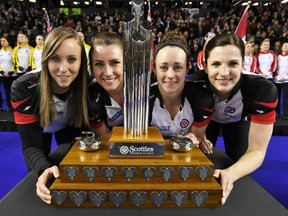 Members of the Team Ontario including, from left, skip Rachel Homan, third Emma Miskew, second Joanne Courtney and lead Lisa Weagle hold up the winner's trophy after winning the Scotties Tournament of Hearts Sunday night in St. Catharines, Ont. The Homan rink defeated Manitoba's Michelle Englot 8-6 in Sunday's gold-medal final.