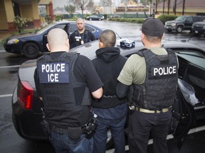 In this photo taken Feb. 7, 2017, released by U.S. Immigration and Customs Enforcement, an arrest is made during a targeted enforcement operation conducted by U.S. Immigration and Customs Enforcement (ICE) aimed at immigration fugitives, re-entrants and at-large criminal aliens in Los Angeles.