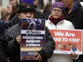 Protesters attend a rally called "We Will Persist," Tuesday, Feb. 21, 2017, in Boston. According to organizers the rally was held to send a message to Republicans in Congress and the administration of President Donald Trump that they will continue to press for immigration rights and continued affordable healthcare coverage.