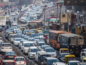 Traffic moves along a highway during evening rush hour in Delhi, India, on Monday, Jan. 11, 2016.