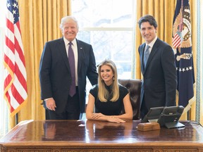 Ivanka Trump sits in the President's chair, flanked by her father Donald and Prime Minister Justin Trudeau in February.