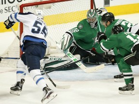 Mark Scheifele, left, of the Winnipeg Jets, tries to find the range past Dallas Stars' goaltender Kari Lehtonen during NHL action Thursday night in Winnipeg. Scheifele had a pair of goals as the Jets beat the Stars 4-3 , giving them three straight victories.